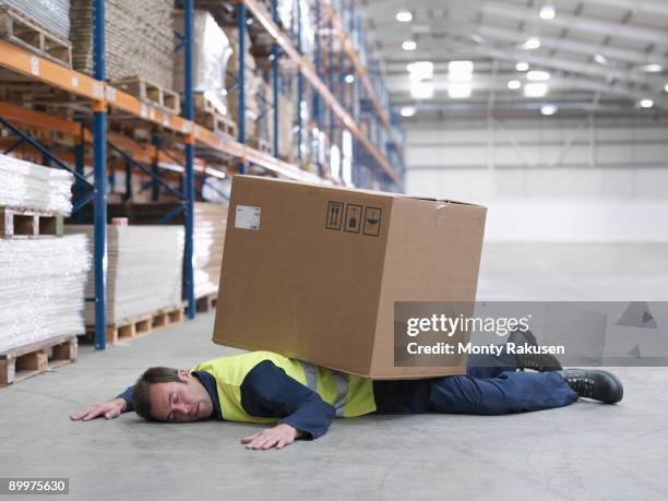 worker flattened by box in warehouse - busy warehouse stock pictures, royalty-free photos & images