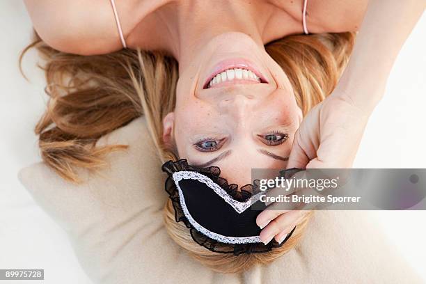 woman waking up - eye mask foto e immagini stock