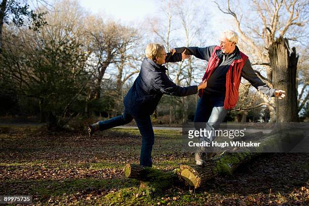 retired couple being playful - tripping stock-fotos und bilder