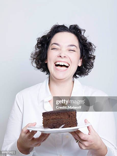 woman holding a plate of cake - woman holding cake stock-fotos und bilder