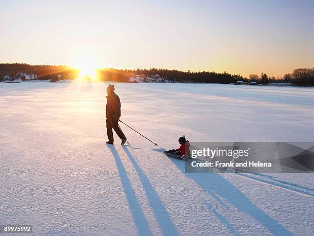 man and boy on snow - grandfather child snow winter stock pictures, royalty-free photos & images