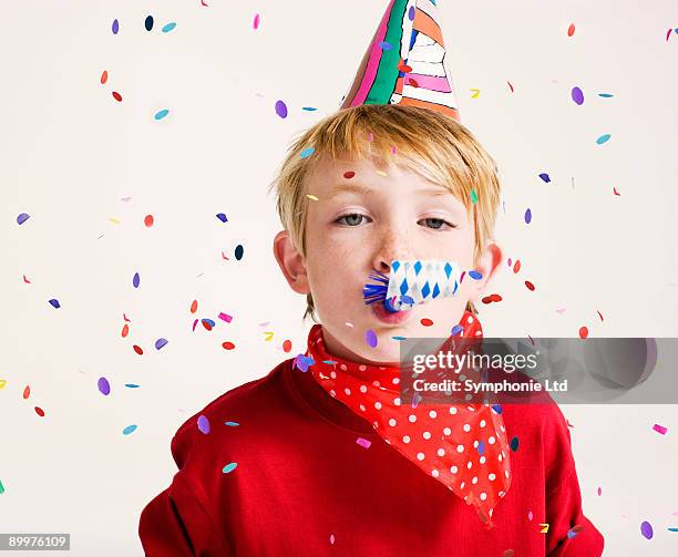 party boy blowing party blower - party blower stock-fotos und bilder