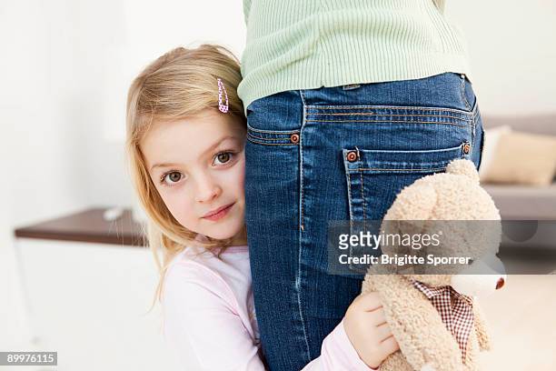 daughter hiding behind mother - shy stock pictures, royalty-free photos & images