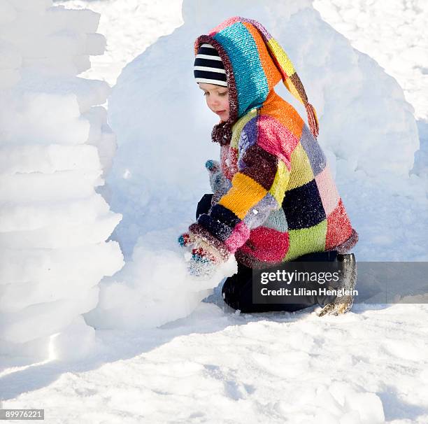 boy building igloo in the snow - igloo isolated stock pictures, royalty-free photos & images