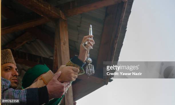 Kashmiri Muslim cleric displaying the holy relic believed to be of Sufi Saint outside the Dastgeer Sahib shrine on the occasion of annual Urs of 11th...