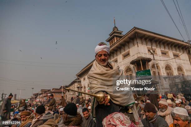 Kashmiri Muslim man douse rose water on the Kashmiri Muslim devotee praying at the Sufi Saint shrine of the Dastgeer Sahib on the occasion of annual...