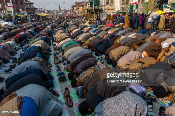 Kashmiri Muslim devotees pray outside the Sufi Saint shrine of the Dastgeer Sahib on the occasion of annual Urs of 11th century Sufi preacher Sheikh...