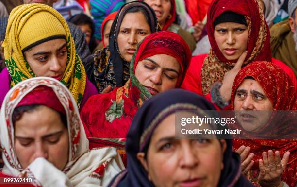 Kashmiri Muslims devotees pray while looking towards a cleric displaying the holy relic believed to be of Sufi Saint outside the Dastgeer Sahib...