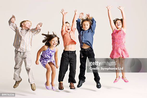 kids jumping - children only stock pictures, royalty-free photos & images