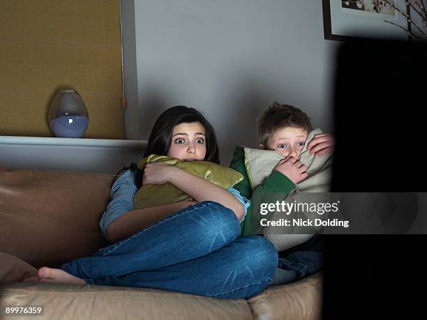 brother and sister watching scary movie - gifted film fotografías e imágenes de stock