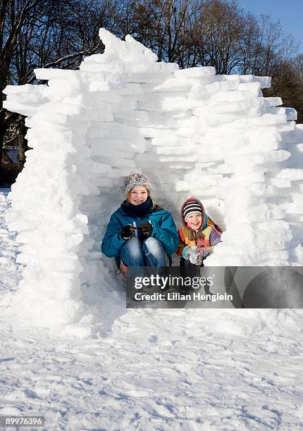 girl and boy in igloo in the snow - igloo isolated stock pictures, royalty-free photos & images