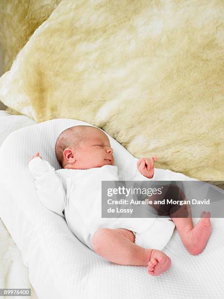 baby in bed - david de lossy sleep stock pictures, royalty-free photos & images