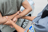 Unrecognizable police officer arrests individual for traffic violation