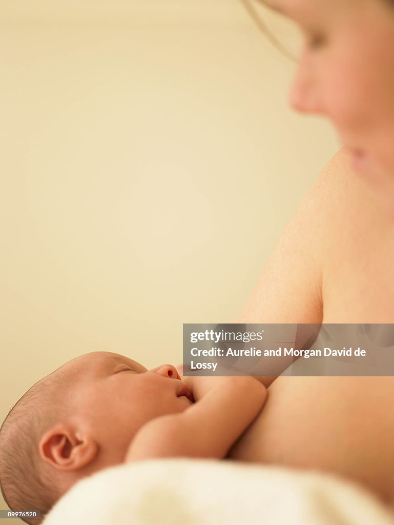 Baby sleeping in mother's arms