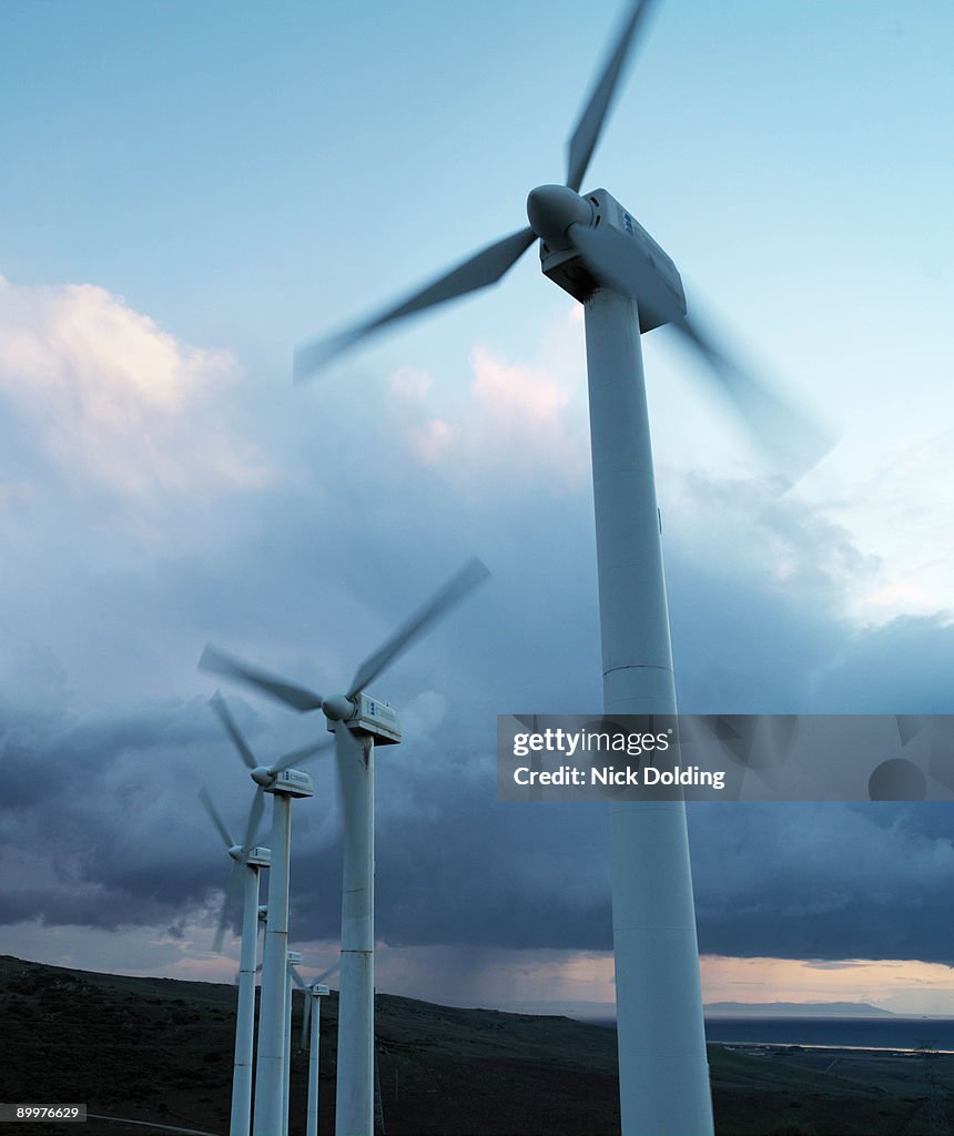 Wind turbines against stormy sky