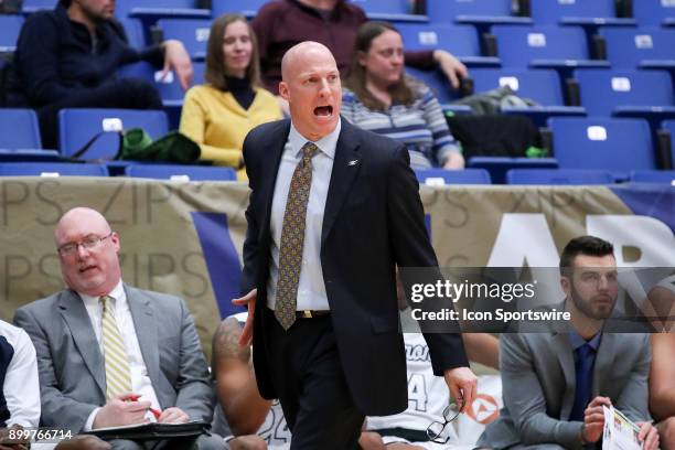 Akron Zips head coach John Groce on the sideline during the second half of the men's college basketball game between the Concord Mountain Lions and...