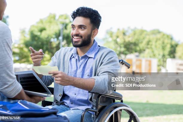 indian college student in wheelchair studying with friend - flash card stock pictures, royalty-free photos & images