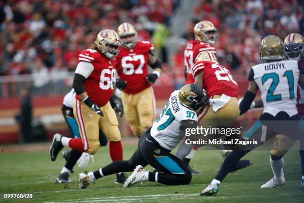 Malik Jackson of the Jacksonville Jaguars tackles Carlos Hyde of the San Francisco 49ers during the game at Levi's Stadium on December 24, 2017 in...