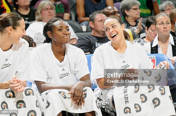 Ruth Riley, Sophia Young, and Becky Hammon of the San Antonio Silver Stars rest on the sidelines during the WNBA game against the Phoenix Mercury on...