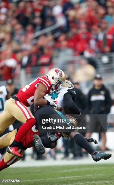 Waun Williams and Ahkello Witherspoon of the San Francisco 49ers tackle T.J. Yeldon of the Jacksonville Jaguars during the game at Levi's Stadium on...