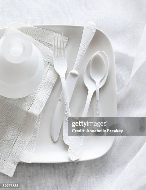 still life of white plastic utensils - plastic plate stock pictures, royalty-free photos & images