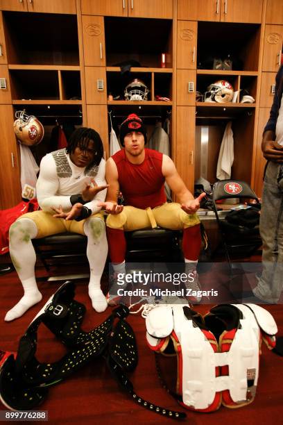 Reuben Foster and George Kittle of the San Francisco 49ers relax in the locker room following the game against the Jacksonville Jaguars at Levi's...