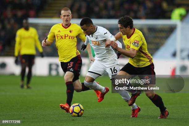 Ben Watson of Watford, Martin Olsson of Swansea City and wa2 battle for possession during the Premier League match between Watford and Swansea City...