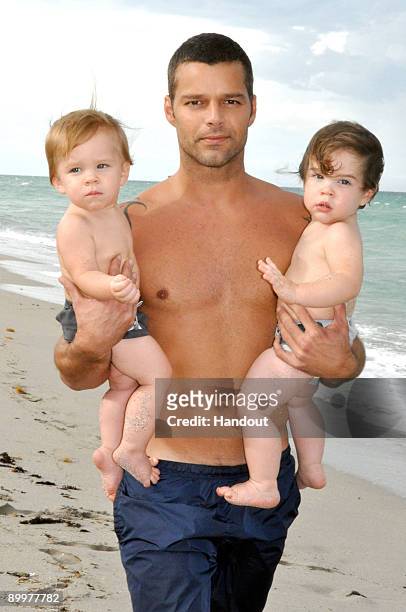In this handout image provided by Ricky Martin, Ricky Martin poses with his sons Valentino and Matteo on August 18, 2009 in Miami, Florida.