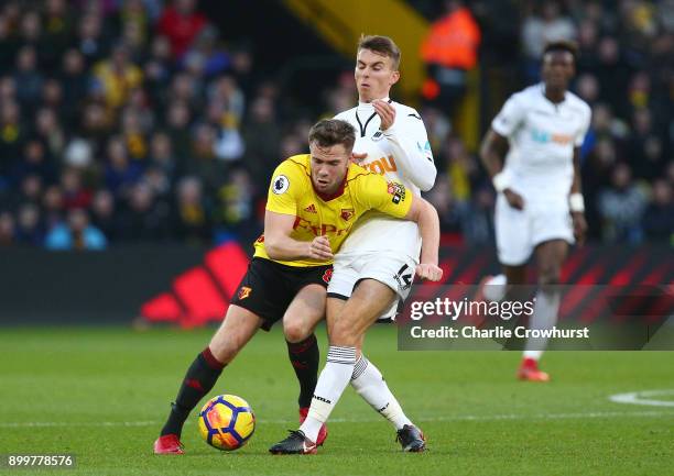 Tom Cleverley of Watford is tackled by Tom Carroll of Swansea City during the Premier League match between Watford and Swansea City at Vicarage Road...