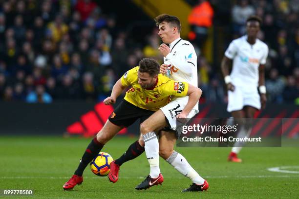 Tom Cleverley of Watford is tackled by Tom Carroll of Swansea City during the Premier League match between Watford and Swansea City at Vicarage Road...
