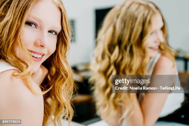 portrait of a young woman in front of a mirror - thin lips stock pictures, royalty-free photos & images