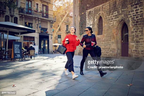 best girlfriends are walking and exploring the gothic quarther - walking street friends stock pictures, royalty-free photos & images