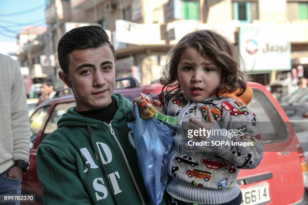Young boy and girl stand outside a Syrian refugee centre in Mafraq, close to the Syrian-Jordanian border. The areas population is now half refugees....