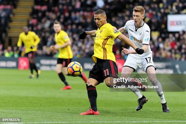 Richarlison of Watford challenged by Sam Clucas of Swansea City during the Premier League match between Watford and Swansea City at the Vicarage Road...