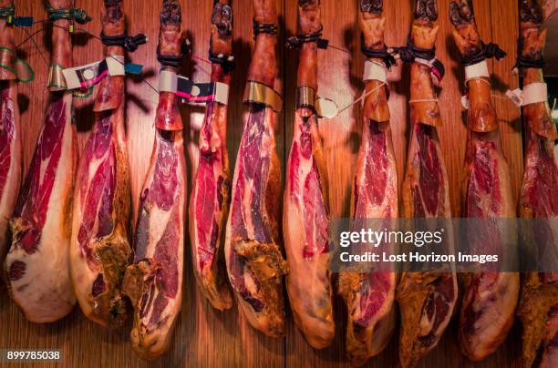 spanish cured ham hanging in boqueria market, barcelona, catalonia, spain, europe - smoked stock pictures, royalty-free photos & images