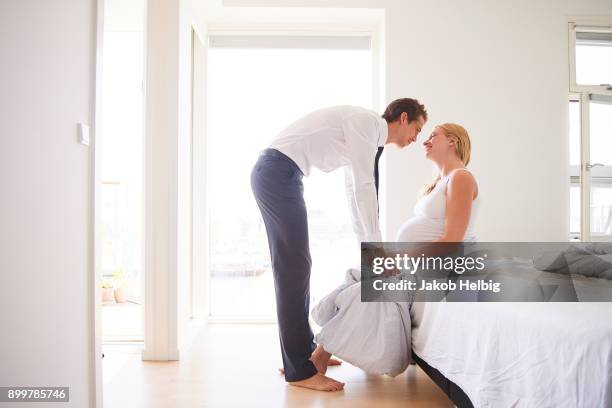 romantic pregnant couple face to face in bedroom - jakob helbig stock pictures, royalty-free photos & images