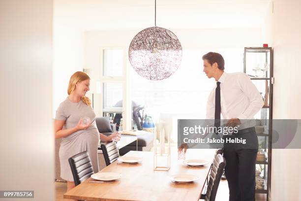 pregnant couple laying dining table - jakob helbig stock pictures, royalty-free photos & images