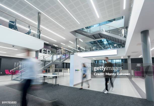 apprentices walking through railway engineering facility - blurred motion foto e immagini stock