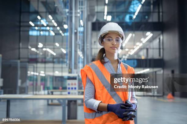 portrait of apprentice in workshop of railway engineering facility - protective workwear foto e immagini stock