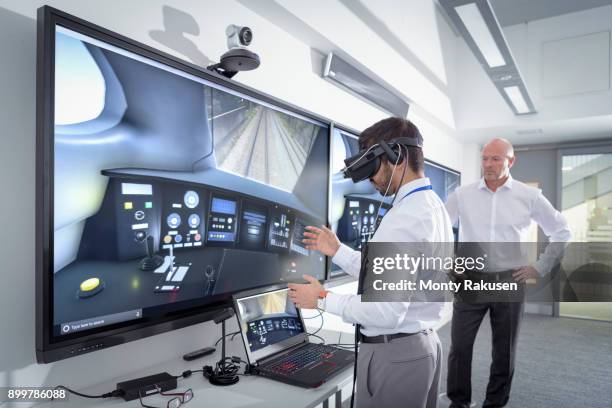 instructor and apprentice using virtual reality system in railway engineering facility - indian engineer stock-fotos und bilder