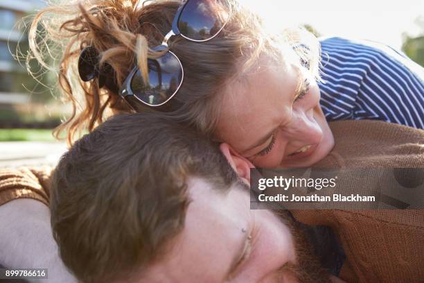 couple lying on roof of canal boat - portare sulla testa foto e immagini stock