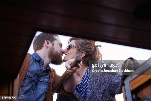 couple steering canal boat - kiss booth stock-fotos und bilder