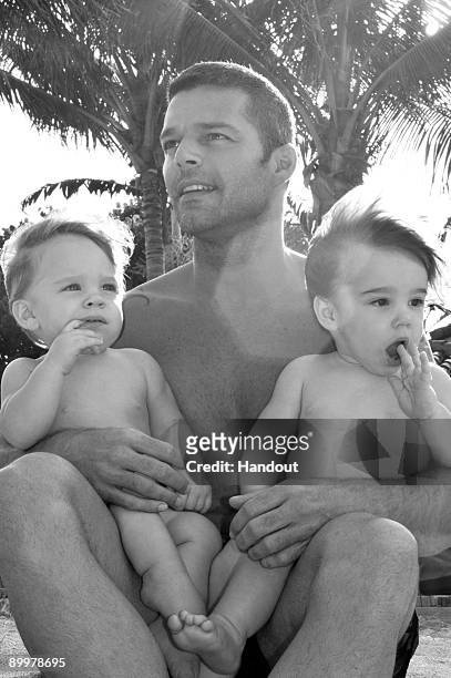 In this handout image provided by Ricky Martin, Ricky Martin poses with his sons Valentino and Matteo on August 18, 2009 in Miami, Florida.