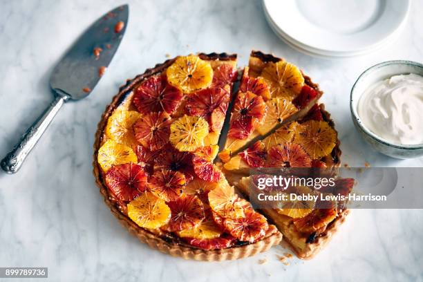 blood orange tart, with cake slice - obsttorte stock-fotos und bilder