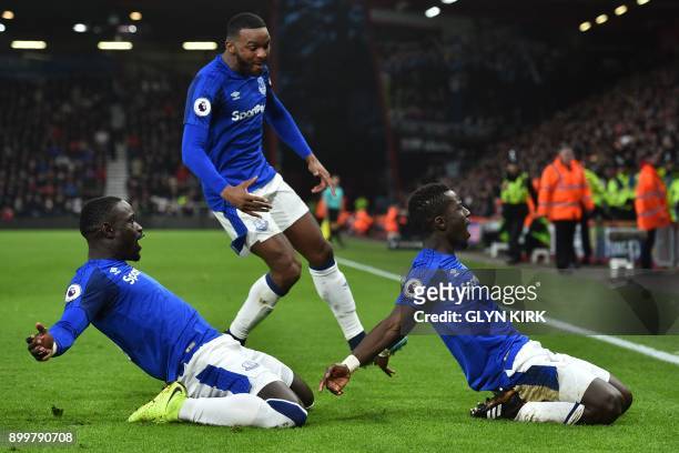 Everton's Senegalese midfielder Idrissa Gueye celebrates with teammates after scoring their first goal during the English Premier League football...