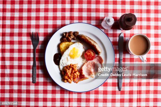 full english breakfast on checked table cloth, overhead view - full english breakfast stock pictures, royalty-free photos & images