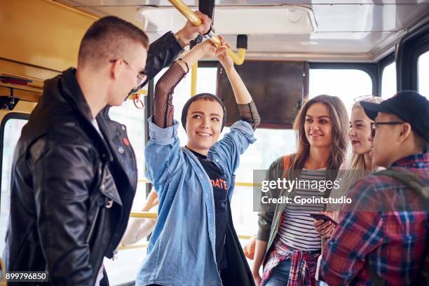 five young adult friends chatting on city tram - tram foto e immagini stock