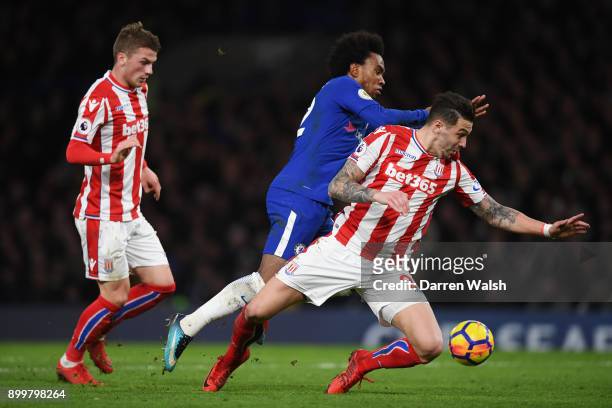 Willian of Chelsea is fouled by Geoff Cameron of Stoke City and consequently awarded a penalty during the Premier League match between Chelsea and...