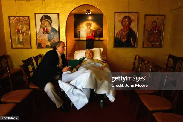 Chaplain Larry Grimm reads scripture to terminally ill hospice resident Chiu Ning Yuan in the chapel of the Hospice of Saint John on August 20, 2009...