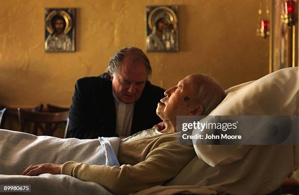 Chaplain Larry Grimm prays with terminally ill hospice resident Chiu Ning Yuan in the chapel of the Hospice of Saint John on August 20, 2009 in...